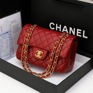 Chanel diamond chain shoulder bag in red with signature quilted design and gold chain, presented in a luxury box.