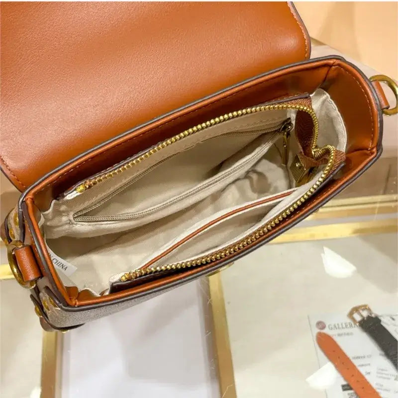 Interior view of the Coach Color Crossbody Handbag showing compartments and high-quality materials.