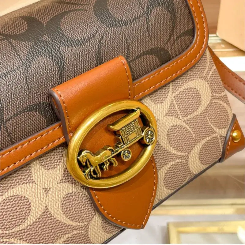 Close-up detail of the Coach Color Crossbody Handbag showcasing the logo and signature craftsmanship.