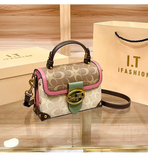 Coach Color Crossbody Handbag displayed on a counter with packaging, showcasing stylish design and high-quality details.