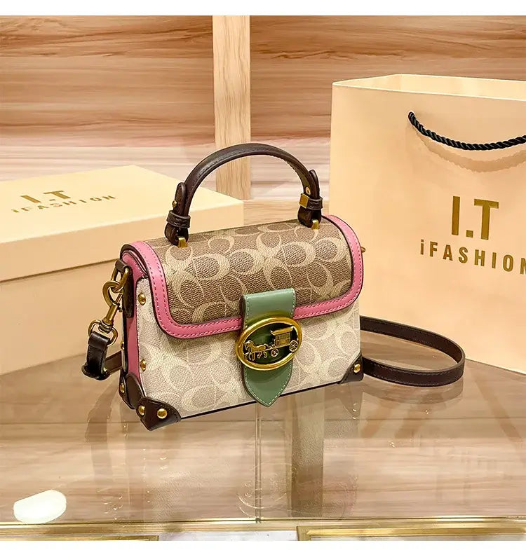 Coach Color Crossbody Handbag displayed on a counter with packaging, showcasing stylish design and high-quality details.