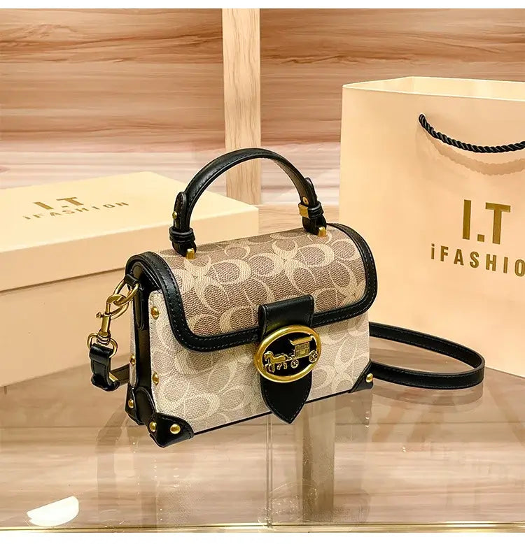Coach Color Crossbody Handbag displayed on a table next to an I.T. fashion shopping bag.