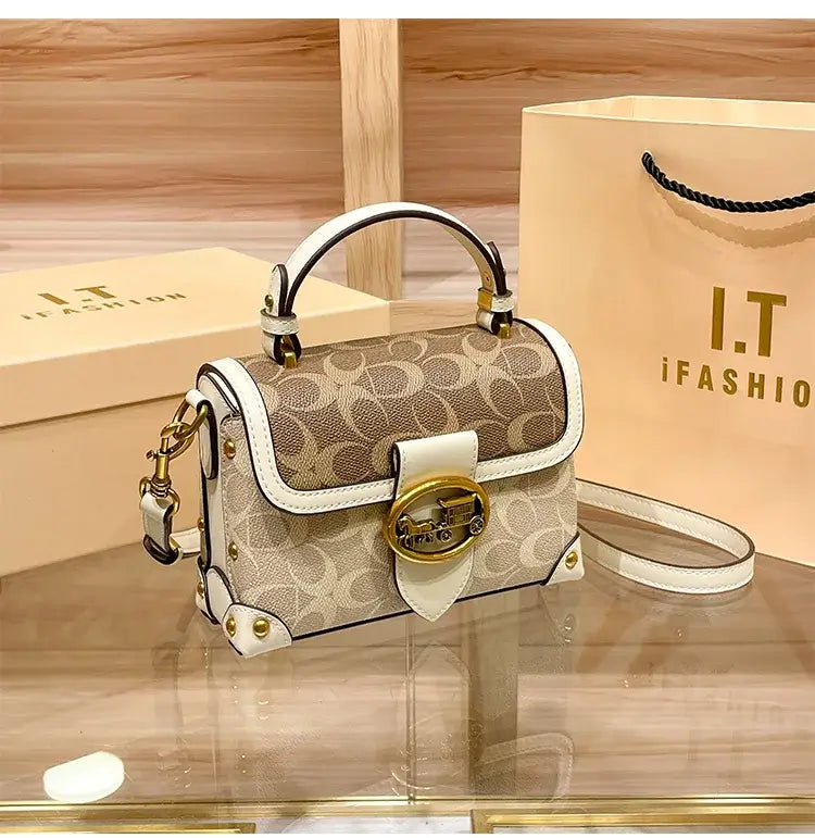 Coach Color Crossbody Handbag displayed on a wooden surface with an I.T. iFashion shopping bag in the background.