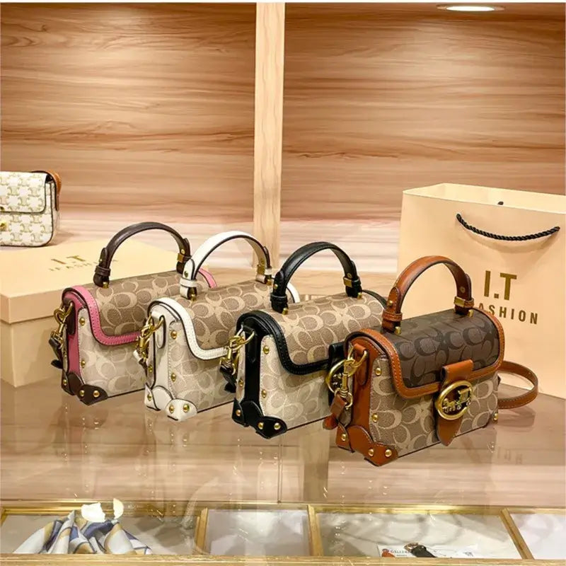 Coach Color Crossbody Handbag collection featuring various colors displayed on a stylish countertop.