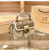 Coach Color Crossbody Handbag displayed on a wooden surface with an I.T. iFashion shopping bag in the background.